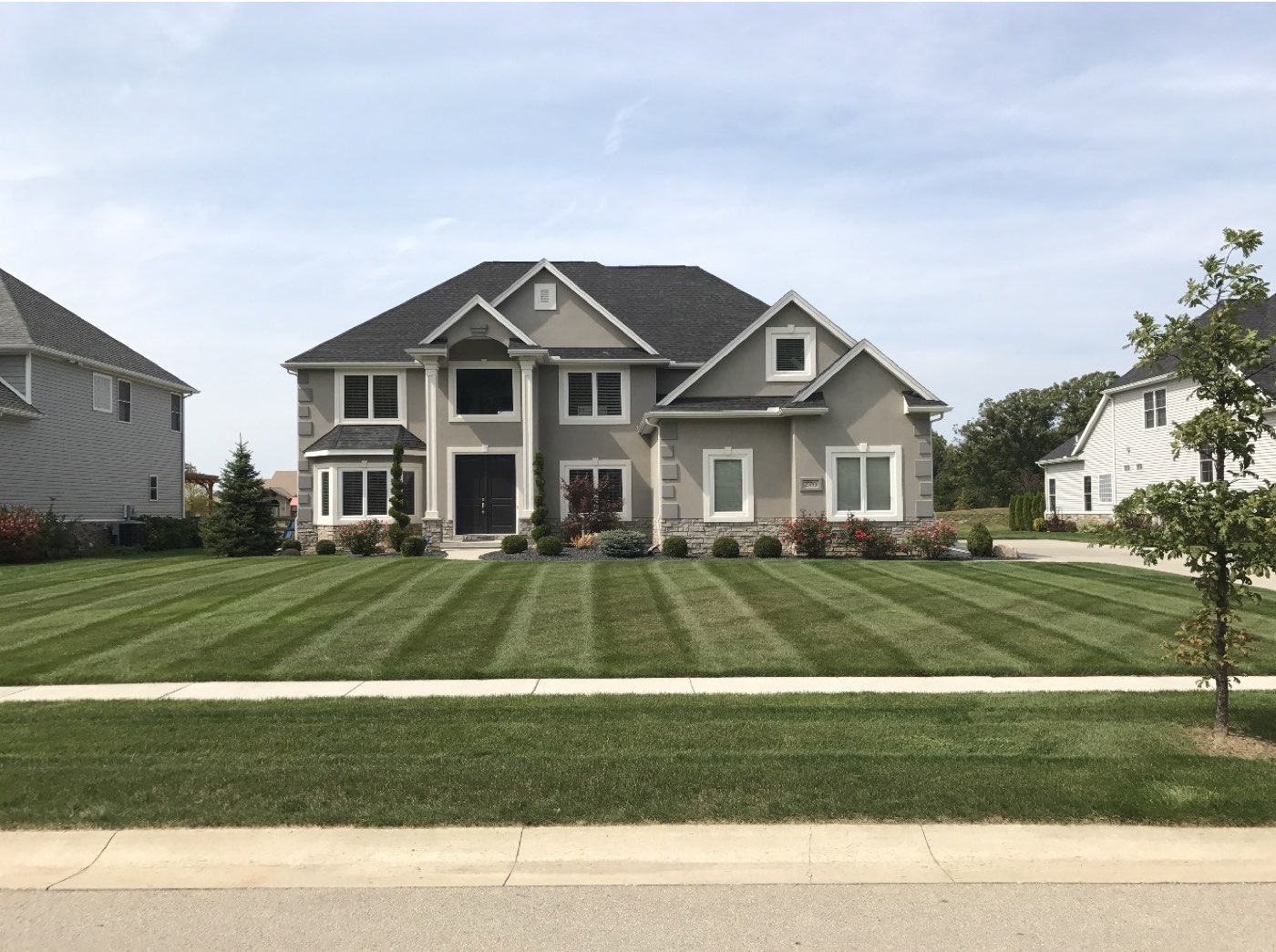 Striped front lawn on a two-story home